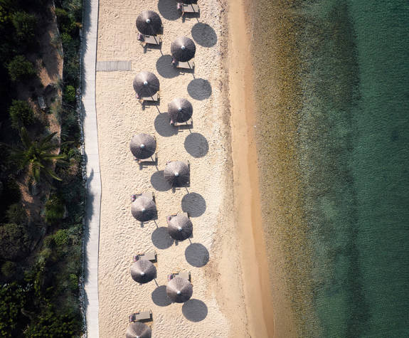 Eagles Resort Chalkidiki sandy beach with trees and umbrellas aerial view