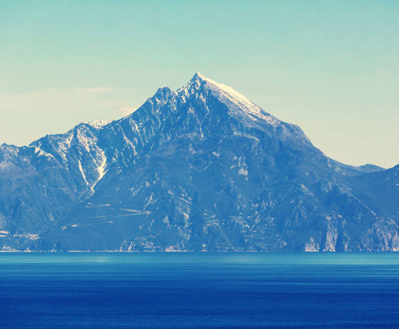 Panoramic view of Mount Athos with snowy peak and blue sea