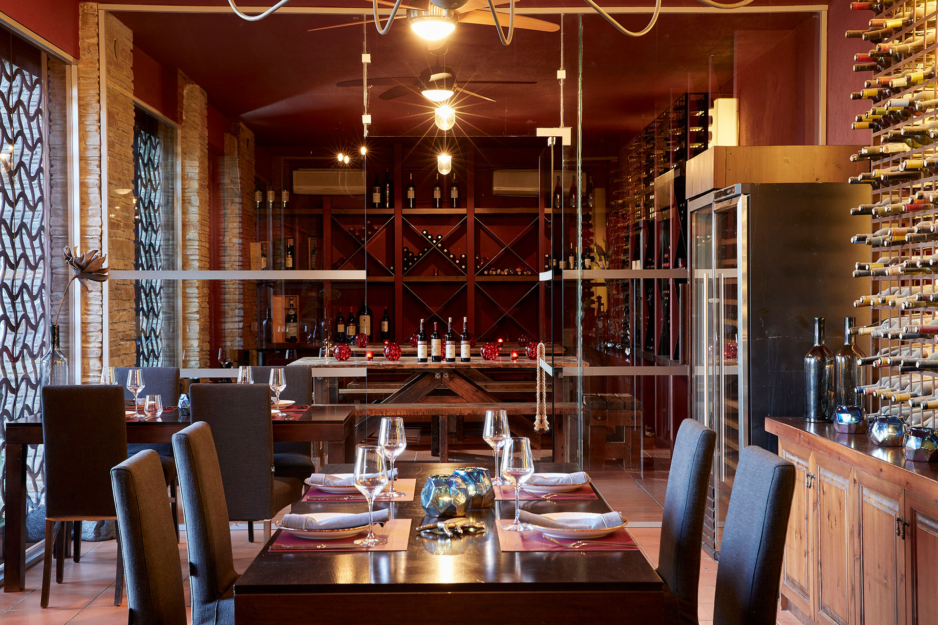 Fine dining tables surrounded by wine racks in elegant cellar-style Vinum restaurant at Eagles Resort