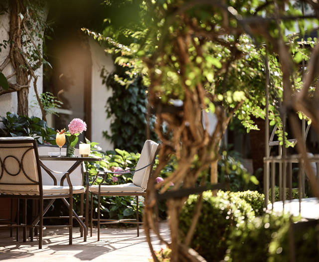 Cafe outdoor seating surrounded by gardens in Eagles Resort