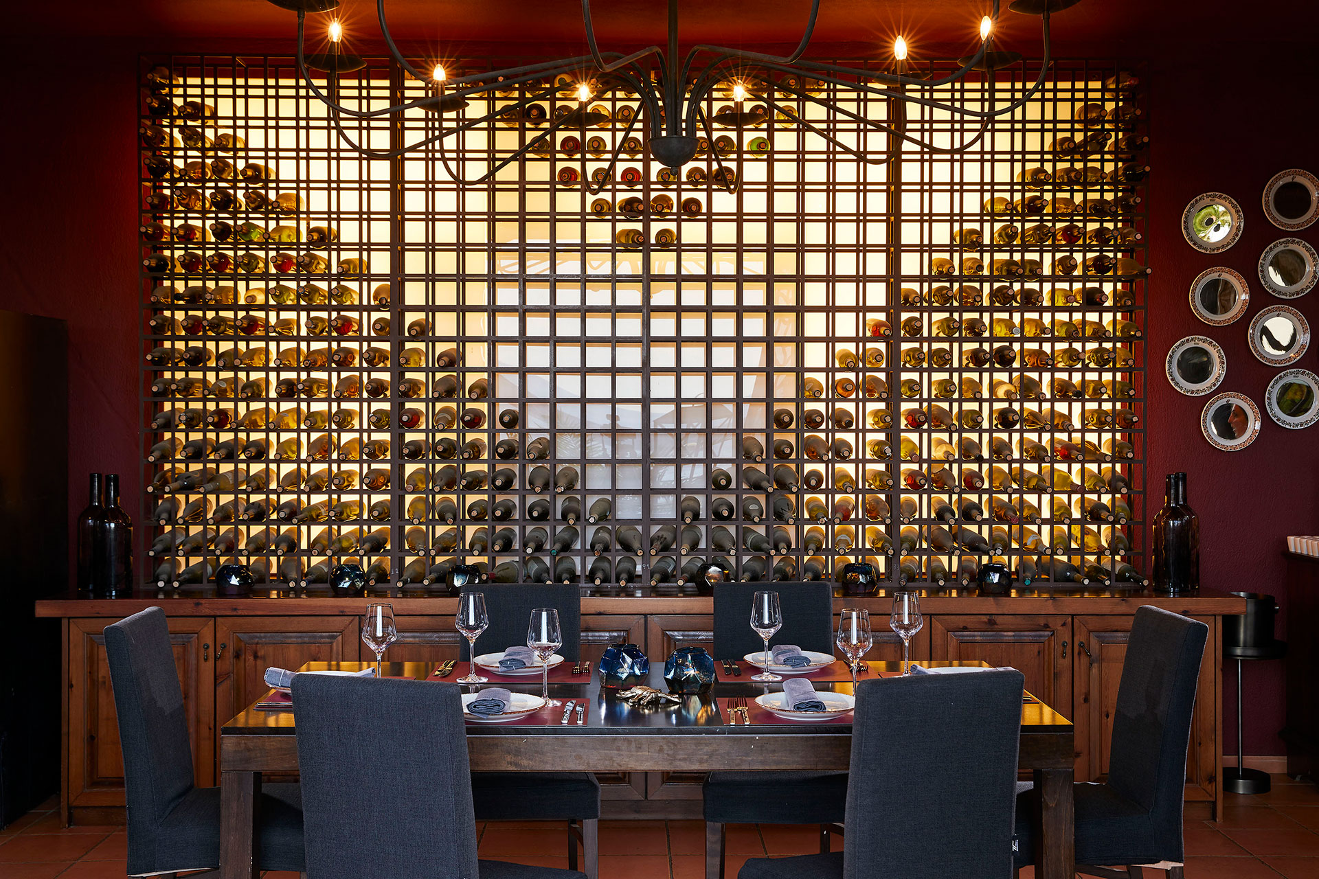 Elegant dining setup with wine wall display in Vinum restaurant interior at Eagles Resort
