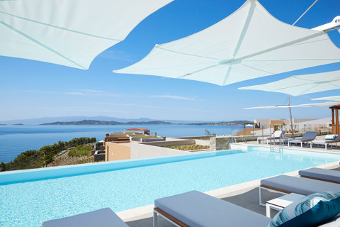 Eagles Resort Chalkidiki infinity Pool with sea and mountain views, and sunbeds