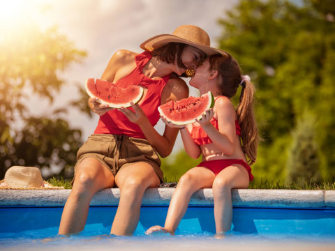 Eagles Resort Chalkidiki mother and doughter enjoying watermelon at the pool