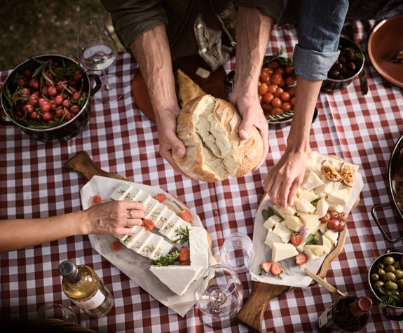 Family eating over a farm-to-table dinner in organic farm at Eagles Resort