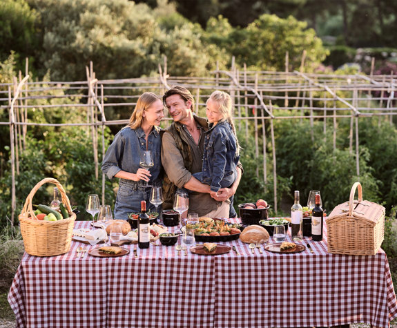 Family toasting over a farm-to-table dinner in organic farm at Eagles Resort