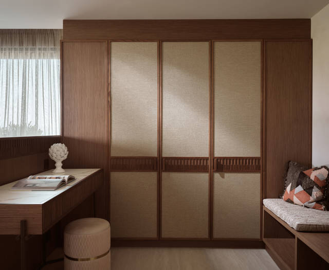 Executive junior suite with wooden wardrobe panels, desk with stool and a cushioned bench