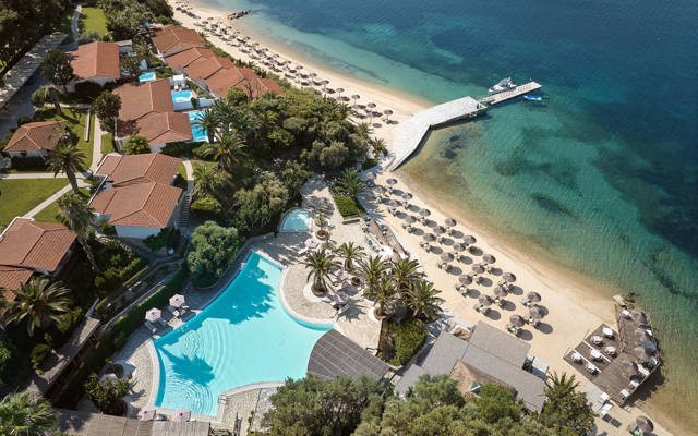 Aerial view of Eagles Resort with accommodations by the sea with private pools and gardens near the sandy beach