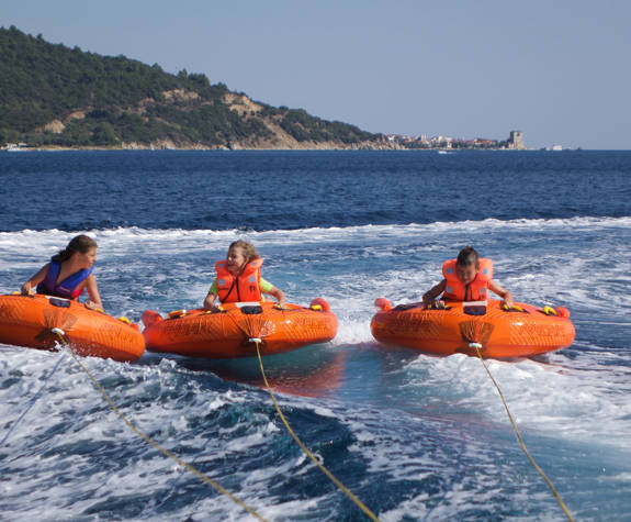 Eagles Resort Chalkidiki Water Sports kids doing ringo at sea