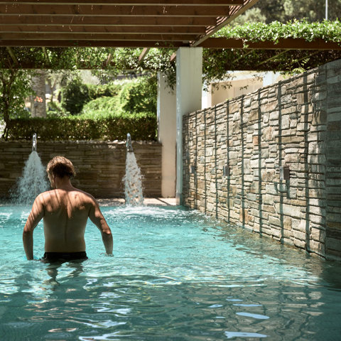 Eagles Resort Chalkidiki Spa man enjoys swimming in the pool