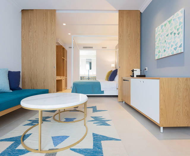 Eagles Palace Resort Chalkidiki two bedroom Suite living room with blue wall and open bedroom
