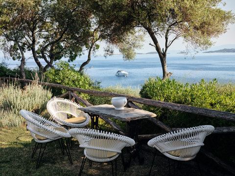 Eagles Resort Club table and chairs under the trees and with sea view