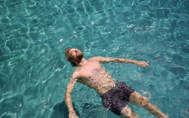 Man relaxing in the clear sea water at Eagles Resort