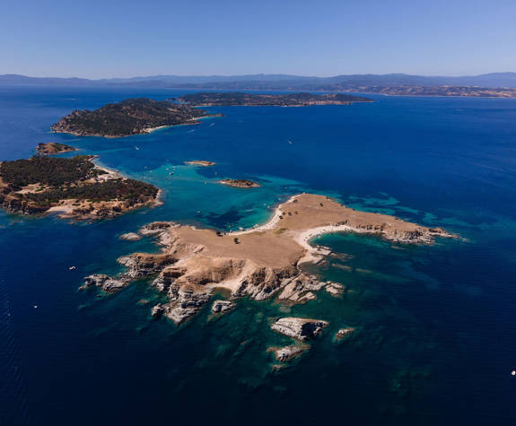Aerial view of Ammouliani island with blue waters and rocky coves