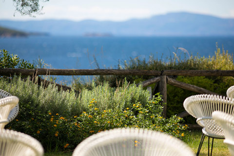 Eagles Resort Chalkidiki white chairs in front of plants and sea views