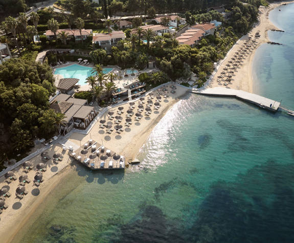 Aerial view of Eagles Resort beach with sun loungers and crystal clear waters