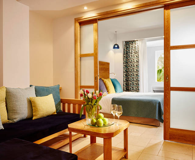 Eagles Palace Resort Chalkidiki Family Suite living room with welcome drink and bedroom
