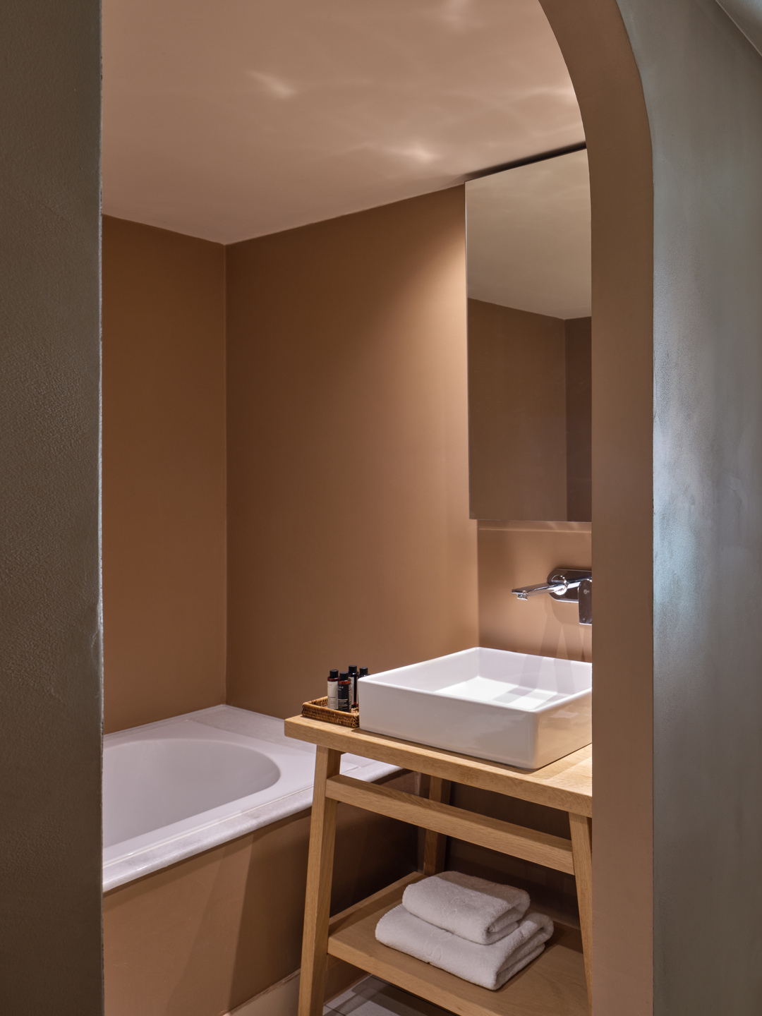 Warm-toned bathroom in a bungalow with vessel sink, wooden vanity and bathtub alcove in Eagles Palace