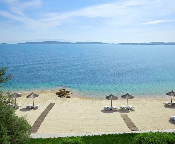 Eagles Resort Chalkidiki Private sandy beach with umbrellas and sunbeds