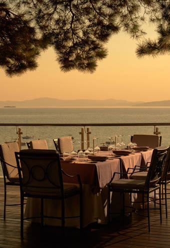 Eagles Resort Chalkidiki Kamares Restaurant tables under the pine trees, at the sunset